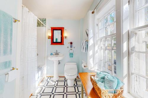 a bathroom with a white toilet and a sink at Water Street Retreat in Sandwich
