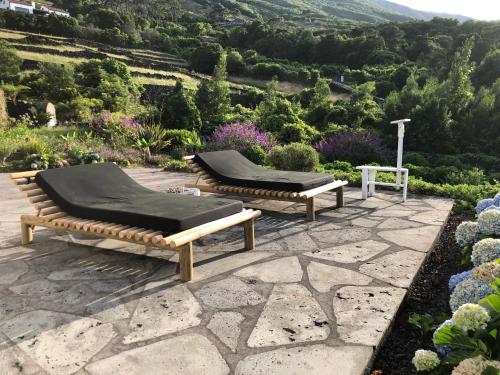 two beds on a patio with a view of a mountain at Casa da Arquinha in Santo Amaro