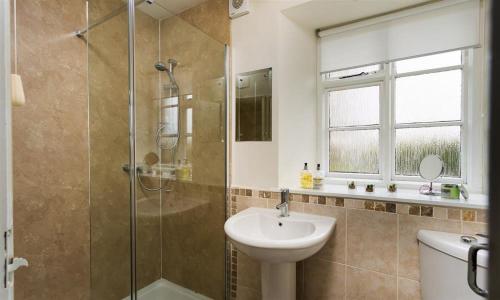 a bathroom with a sink and a shower at The Old Chapel in Windermere