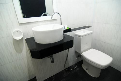 a bathroom with a white toilet and a sink at Lanta Memory Resort - SHA Plus in Ko Lanta