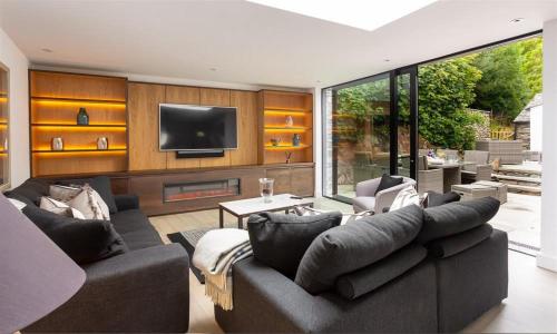 a living room with a couch and a tv at Underhowe in Grasmere