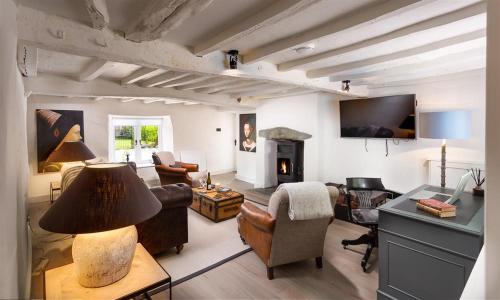 a living room filled with furniture and a fireplace at Underhowe in Grasmere