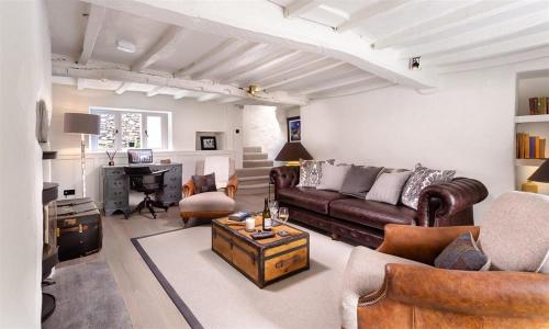 a living room with a couch and a desk at Underhowe in Grasmere