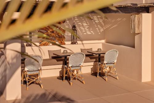 a table and chairs in a room with a table at Kimpton Mas Olas Resort and Spa in Todos Santos