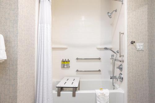 a white bathroom with a tub and a shower at Holiday Inn Express & Suites - San Jose Silicon Valley by IHG in San Jose