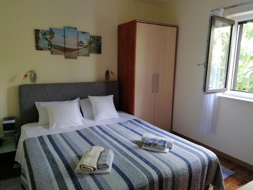 a bedroom with a bed with two towels on it at Apartments with a parking space Njivice, Krk - 5320 in Njivice
