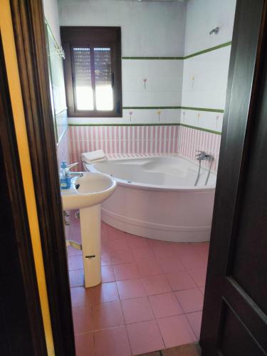 a bathroom with a tub and a sink at El Corchuelo in Corteconcepción