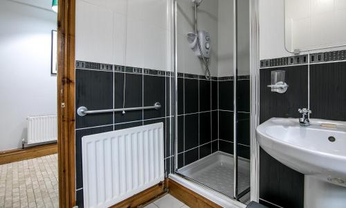 a bathroom with a sink and a shower at Simcas House in Stainton