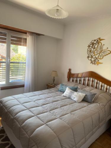a large bed in a bedroom with a window at Alberdi Centro in Tandil