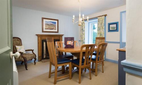 a dining room with a table and chairs at Rose Cottage Coniston in Coniston