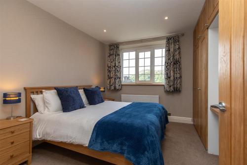 a bedroom with a large bed and a window at Gale Mews in Ambleside