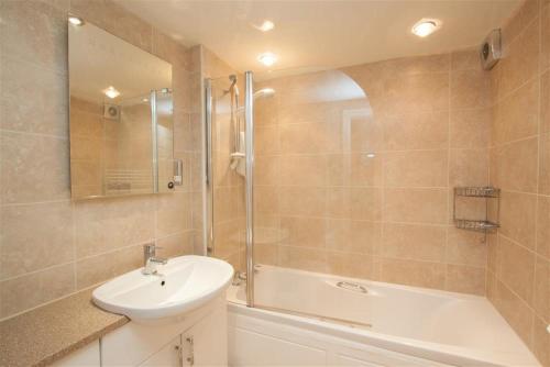 a bathroom with a sink and a shower and a tub at Over Ghyll in Ambleside