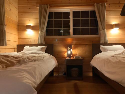 Ένα ή περισσότερα κρεβάτια σε δωμάτιο στο 安曇野遊人Ｃ.Ｌ.Ｊ.クラブ