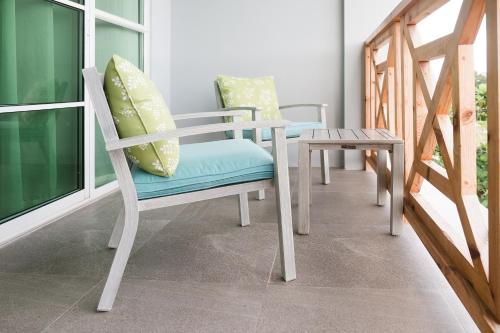 a room with two chairs and a table at Sunrise by white sand dhigurah in Dhigurah