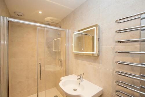 a bathroom with a shower and a sink at Chapel Hill Cottage in Ambleside