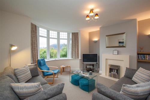 a living room with two couches and a fireplace at Riggside in Keswick