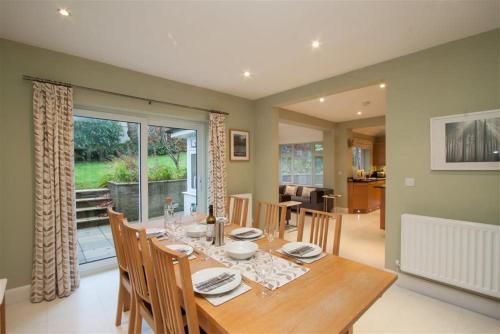 a dining room with a table and chairs and a window at Riggside in Keswick