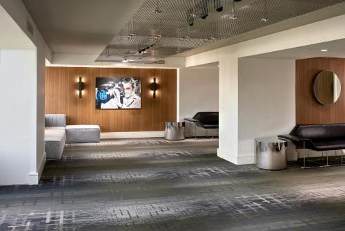 a lobby with furniture and a painting on the wall at Kimpton Hotel Palomar Los Angeles Beverly Hills by IHG in Los Angeles