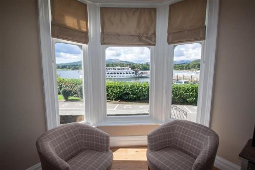 a room with two chairs and a large window at Waterside in Ambleside