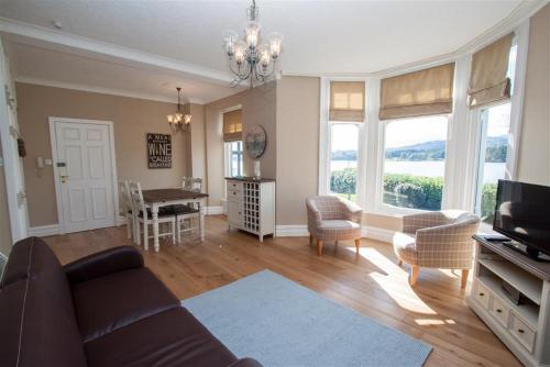 a living room with a couch and chairs and a table at Waterside in Ambleside