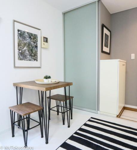a kitchen with a table and chairs and a refrigerator at NEW! Relaxing Prime Unit in the Heart of Shibuya! in Tokyo