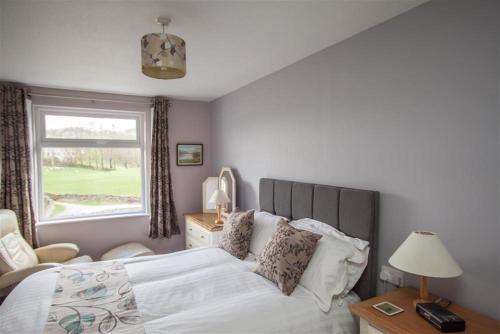 a bedroom with a large bed and a window at Mellbreak in Chapel Stile