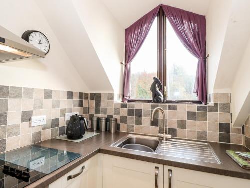 a kitchen with a sink and a window at Squirrel Bank in Ambleside