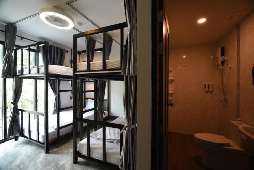 a room with bunk beds and a bathroom at KOKO Party Hostel in Ao Nang Beach