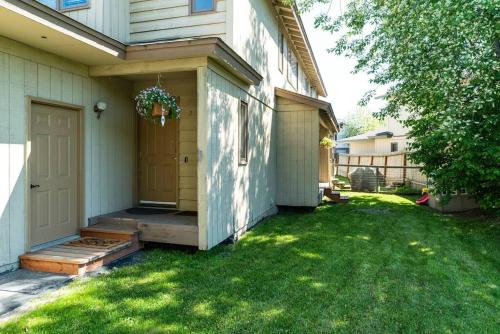 a porch of a house with a door and a yard at Moose Meadows- Near the airport, centrally located in Anchorage