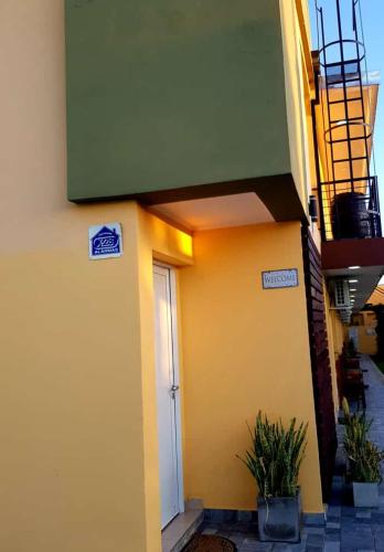a building with a door and plants in front of it at Raíces Federaenses Monoambientes in Federación
