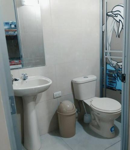 a bathroom with a toilet and a sink at Casa amoblada y cómoda en BALLENITA, Santa Elena. in Ballenita