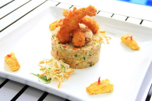 a plate of food with shrimp and noodles on it at Vrata Hotel Yogyakarta in Kalasan