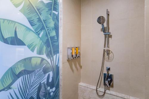 a bathroom with a shower with a shower head at Panan Krabi Resort in Ao Nang Beach