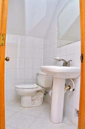 a bathroom with a sink and a toilet at Apartamentos El Peñón del Rodadero VISTA AL MAR - By Apartamar Santa Marta in Santa Marta
