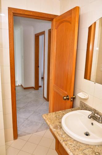 a bathroom with a sink and a mirror at Apartamentos El Peñón del Rodadero VISTA AL MAR - By Apartamar Santa Marta in Santa Marta