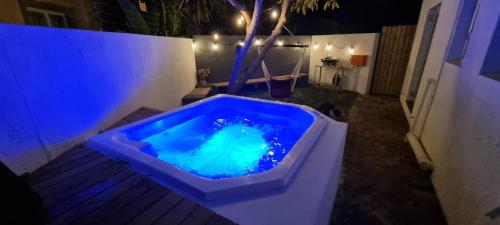 a blue tub filled with blue water sitting on a patio at Sunshowers Plett in Plettenberg Bay
