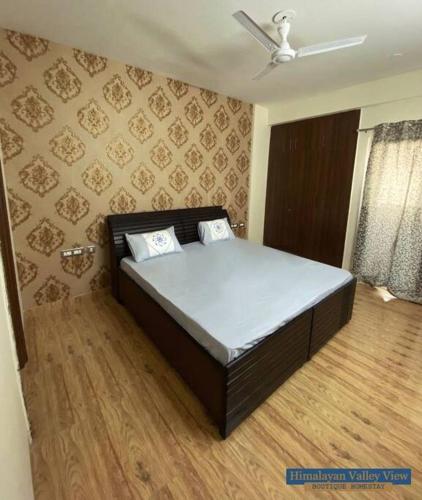 a bedroom with a bed in a room at Himalayan Valley View - A boutique homestay in Dehradun