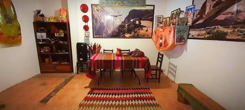 une salle à manger avec une table et un tissu de table coloré dans l'établissement Sumac wasi, à Chivay