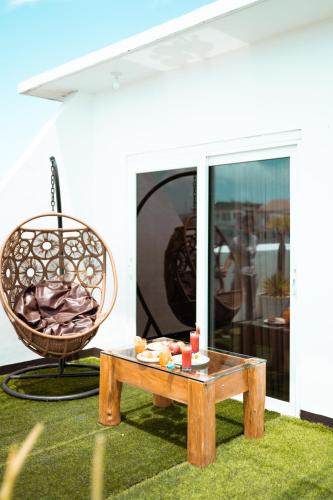 a coffee table and a chair on a patio at Jony's Boutique Hotel in Boracay