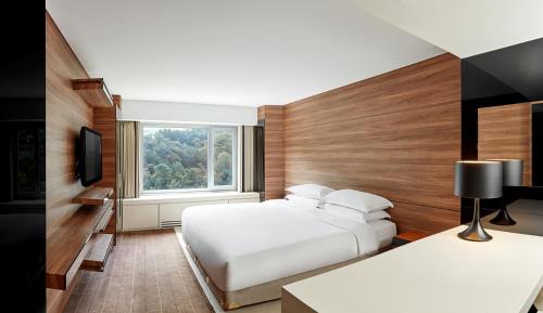 a hotel room with two beds and a window at Grand Walkerhill Seoul in Seoul