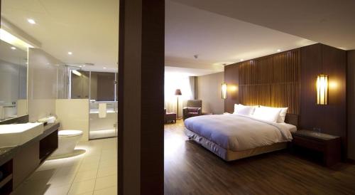 Una cama o camas en una habitación de Guide Hotel Taipei Bade