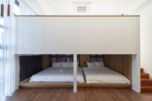 a bedroom with a large white canopy bed at Space and Mood in Busan