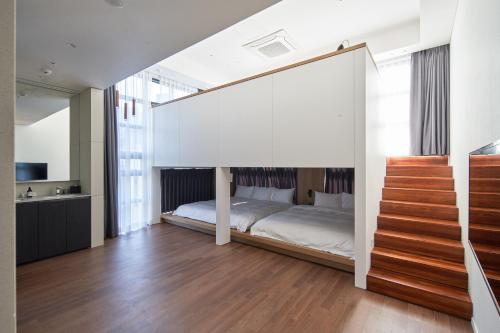 a bedroom with a bed and a staircase at Space and Mood in Busan
