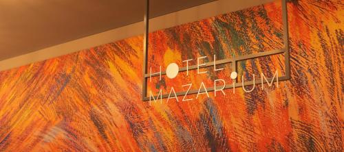 a colorful wall with a sign on it at Hotel Mazarium in Morioka
