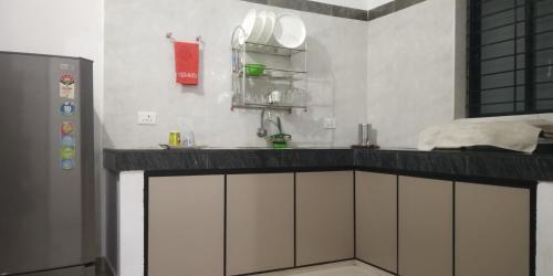 a kitchen with a counter top and a sink at Pearl Inn in Kottakkal