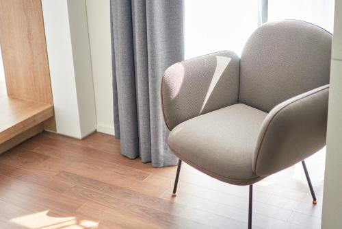 a chair sitting in front of a window at Space and Mood in Busan