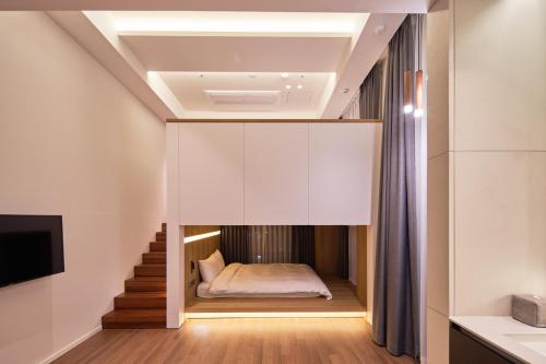 a small bedroom with a bed in a room at Space and Mood in Busan