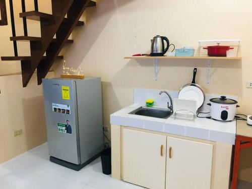 een keuken met een wastafel en een koelkast bij 2 storey Camella Homes in Pagadian City in Pagadian