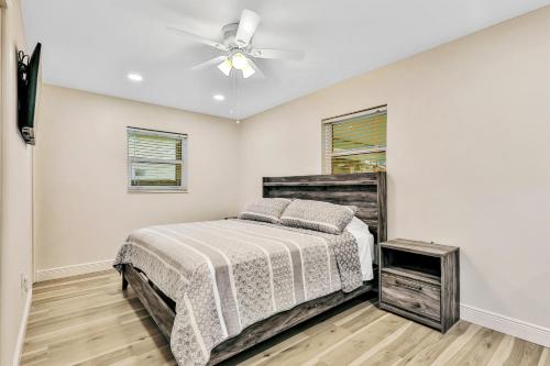 a bedroom with a bed and a ceiling fan at Uncork and Unwind You are on Lake Time in Sebring