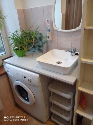 a bathroom with a sink and a washing machine at Riga, Jelgavas street 48. in Rīga